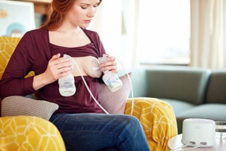 mother pumping breast milk using philips avent electric breast pump